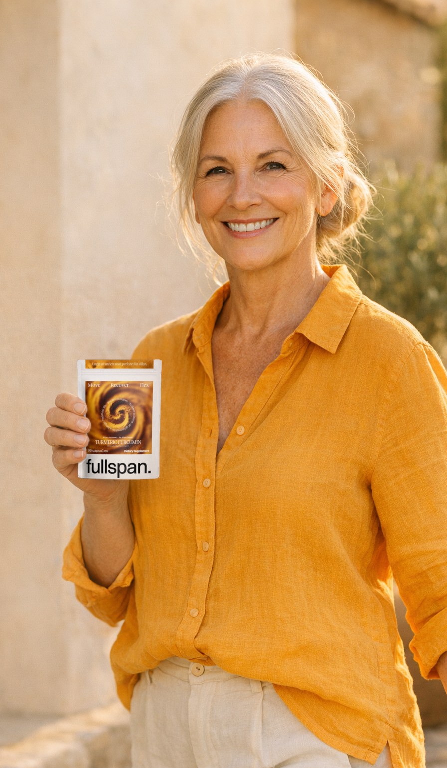 Smiling woman holding a pouch of fullspan turmeric